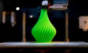 a green color beautiful vase being 3d printed