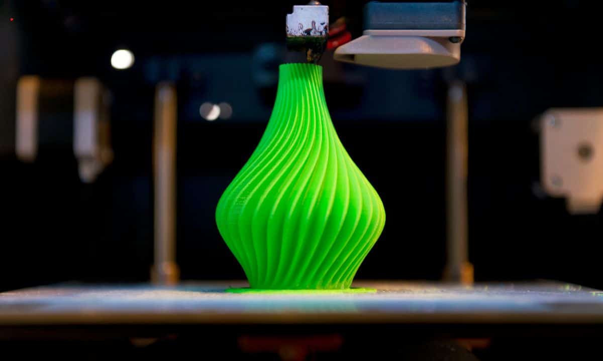 a green color beautiful vase being 3d printed