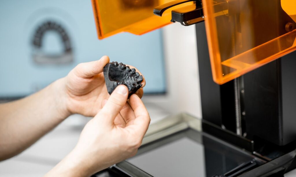 a person 3d printing a black colored jaw model in a 3d printer - What Are 50 Cool Things to 3D Print?