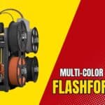 FLASHFORGE AD5X multi-color 3D printer with a sleek metal frame, displaying a vibrant 4-color print on its build plate.