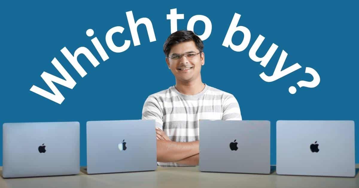 M1 vs M2 vs M3 vs M4 MacBook Air - A smiling Indian man standing behind a table with Apple Macbook Air M1, M2, M3, and M4 laptops