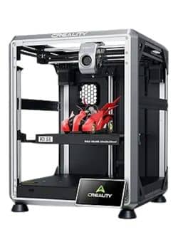 A white Creality K1 SE 3D printer with a transparent enclosure, showcasing a red 3D-printed race car on its build plate. The printer has a digital display at the bottom front.