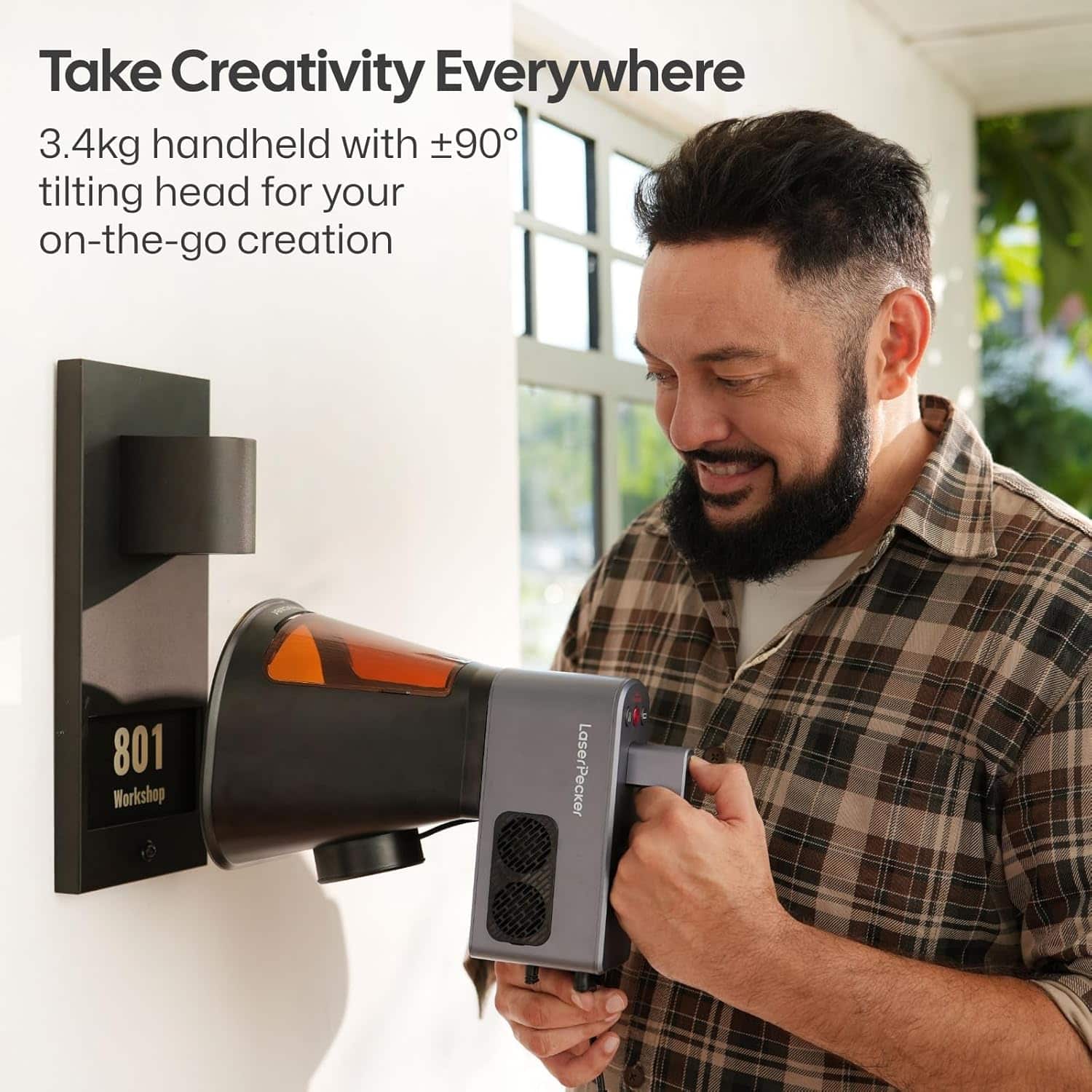 LaserPecker LP2 Plus handheld use shown engraving on a vertical surface demonstrating portability